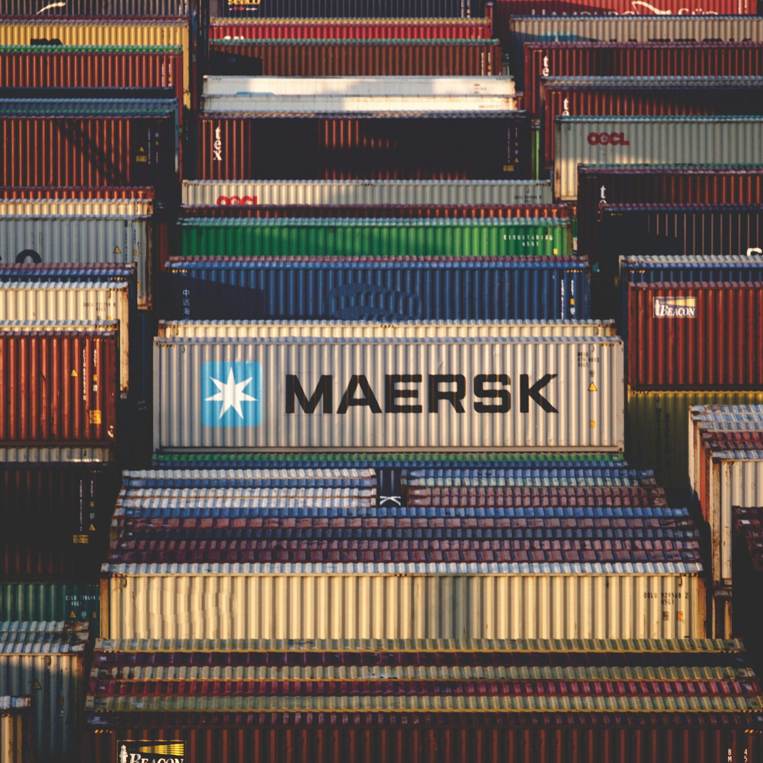 A vibrant collection of cargo containers stacked at a bustling shipping port.